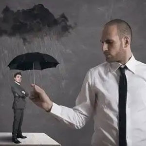A man protecting another man with an umbrella - Vision Law